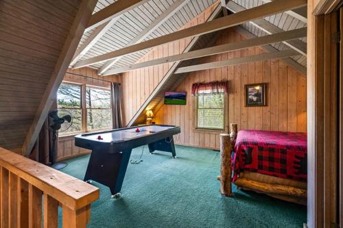 a room with a pool table in a attic at Ridgecrest in Gatlinburg