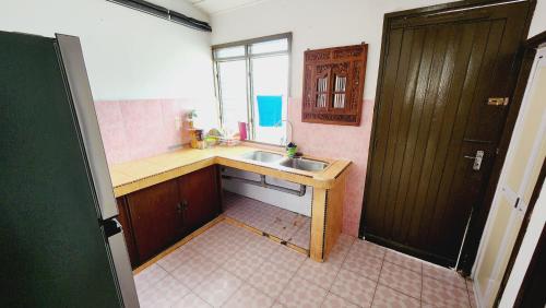 a small kitchen with a sink and a window at HOMESTAY@344 in Kampong Permatang