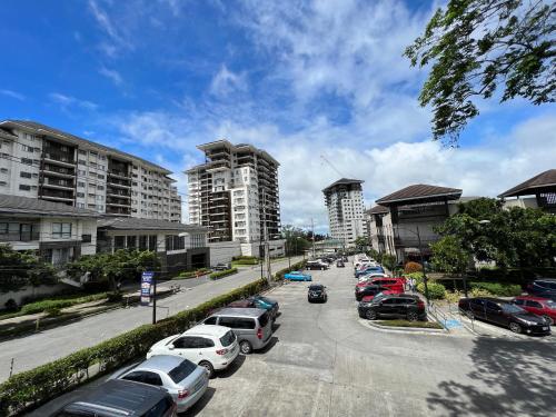 a street with cars parked in a parking lot at JmR Serin West studio unit pay by Gcash or cash only in Tagaytay