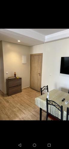 a living room with a table and a wooden door at Marina saidia in Oujda