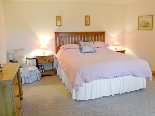 a bedroom with a bed and a desk and a chair at Mill Moor - B6064 in Pooley Bridge
