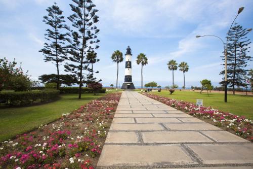 a walkway leading to a lighthouse in a park at MLA Apartments - Alcanfores in Lima