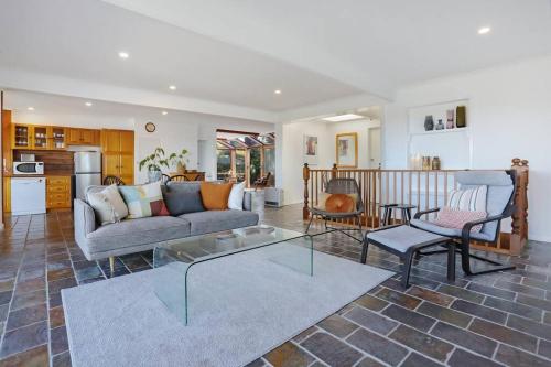 a living room with a couch and a table at Aqua La Vista - 4 Bedroom Pet Friendly House in Merimbula