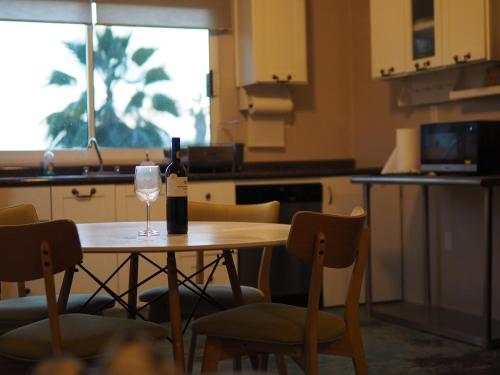 a bottle of wine sitting on a table in a kitchen at Mystic Breeze in El Pescadero