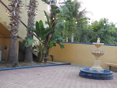a fountain in the middle of a courtyard with trees at Mystic Breeze in El Pescadero