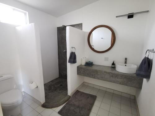 a bathroom with a sink and a mirror at Mystic Breeze in El Pescadero
