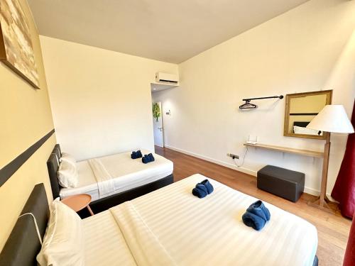 a hotel room with two beds in a room at AJ Suites @ Loft Imago KK in Kota Kinabalu