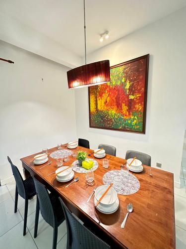 a dining room with a wooden table and chairs at AJ Suites @ Loft Imago KK in Kota Kinabalu
