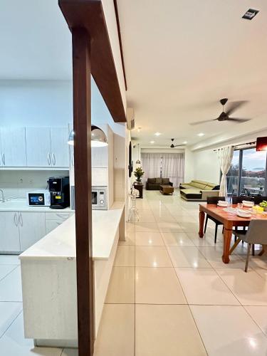 a kitchen and living room with a table and a couch at AJ Suites @ Loft Imago KK in Kota Kinabalu