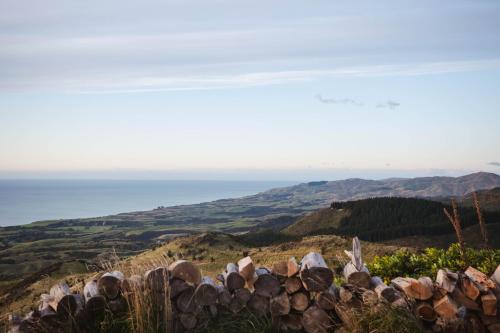 a pile of logs on top of a hill at Matai Peak Lodge in Hundalee