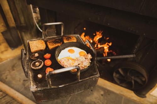 a pan of food is cooking in an oven at Matai Peak Lodge in Hundalee