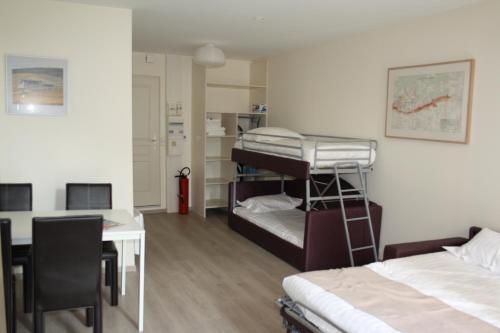 a room with a desk and a bed and a deskablish at Gites du Beffroi in Nuits-Saint-Georges