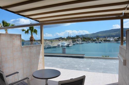 a patio with a view of a marina at Kosta Palace in Kos Town