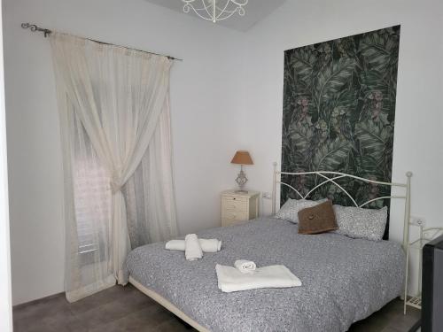 a bedroom with a bed with towels on it at Your House in Menorca in Ciutadella