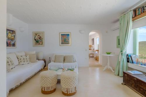 a white living room with a couch and a table at Mykonos Citadel in Mikonos
