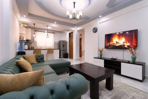 a living room with a couch and a fireplace at Arabel House Two Bedroom Nanyuki in Nanyuki