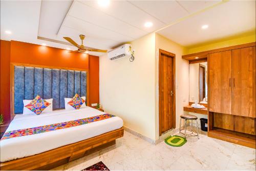 a bedroom with a large bed in a room at FabHotel Aqua Tulip in Kolkata