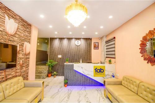 a lobby with a reception desk and a chandelier at FabHotel Aqua Tulip - Nr Milan Mela in Kolkata