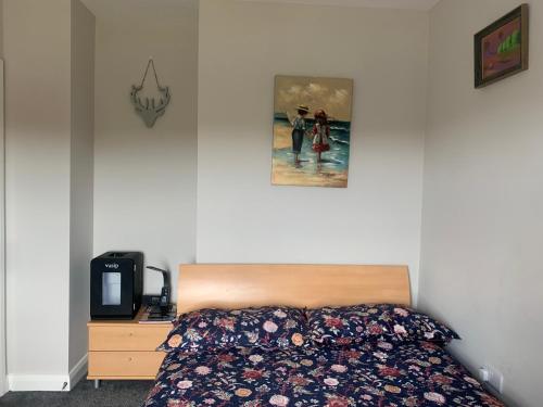ein Schlafzimmer mit einem Bett und einem Bild an der Wand in der Unterkunft Room with a view in Newry