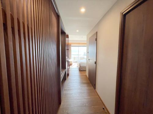 a hallway leading to a room with a bed at Golden Tulip Porto-Vecchio in Porto-Vecchio