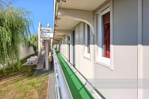 a building with a green stripe on the side of it at Première Classe La Roche Sur Yon - Vendéspace in Mouilleron-le-Captif