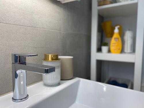 a bathroom sink with a faucet on top of it at GLAD Spot - Liestal - 10 min from Basel - Central, Design, Modern in Liestal