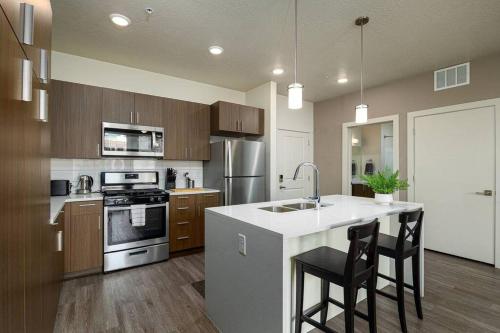 a kitchen with a sink and a stove top oven at Modern 1B Downtown SLC with WFH Setup, Gym, Fast Wi-Fi, Pool in Salt Lake City