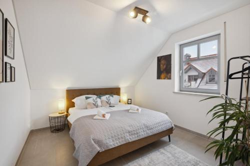 a bedroom with a bed with two towels on it at smooth living Apartments Augsburg Lechhausen - Free parking in Augsburg