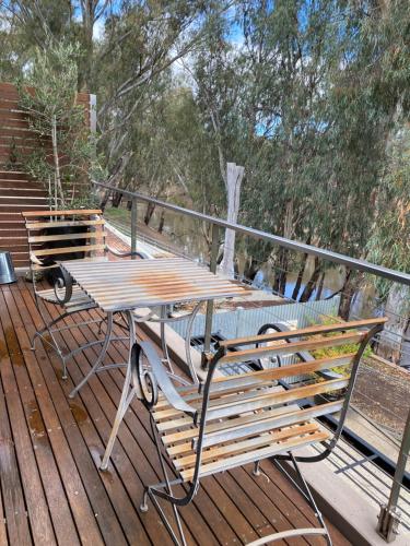 a picnic table and bench on a deck at Adelphi Apartments 3 or 3A - Downstairs 2 Bedroom or Upstairs King Studio with Balcony in Echuca