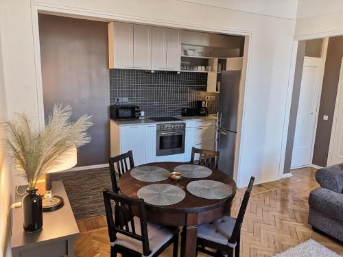 a kitchen and dining room with a table and chairs at Gonsiori 3 Tenors Apartment in Tallinn