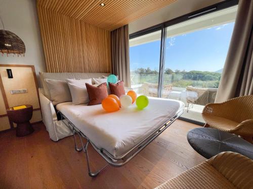 a room with a bed with some fruit on it at Golden Tulip Porto-Vecchio in Porto-Vecchio