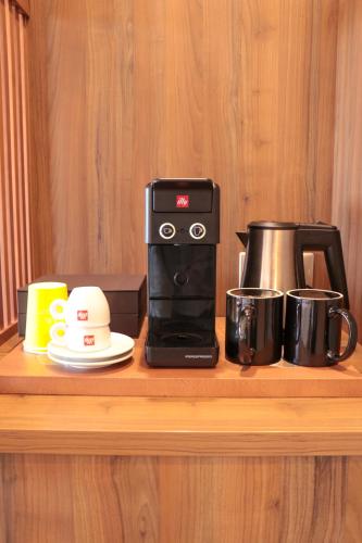a counter with a coffee maker and a toaster at Golden Tulip Porto-Vecchio in Porto-Vecchio