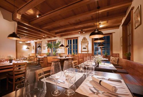 a restaurant with a long table with wine glasses at Le Mont-Vully - Hôtel Restaurant in Haut-Vully