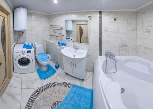 a bathroom with a tub and a toilet and a sink at Luxury apartment Sicheslavska street in Kryvyi Rih