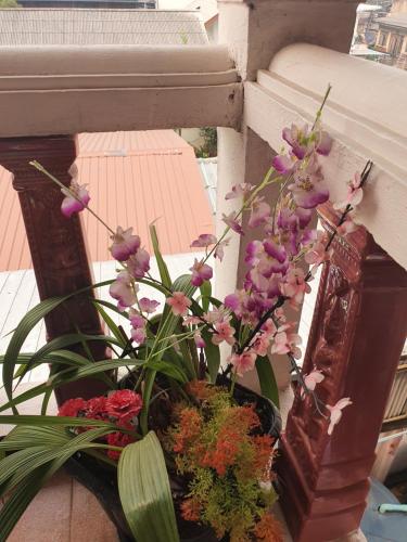 a vase of flowers sitting on a window sill at Like Home in Chiang Mai