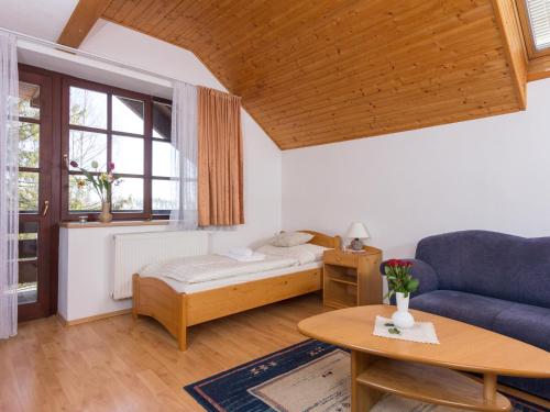 a living room with a couch and a table at Villa Tatry Stola in Vyšné Hágy