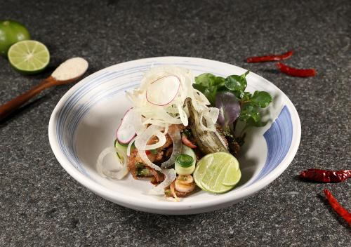 a plate of food with seafood and vegetables on a table at Ad Lib Hotel Khon Kaen in Khon Kaen