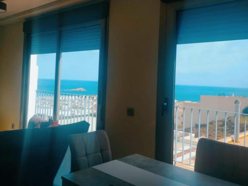 a room with a balcony with a view of the ocean at Luz de Mar. in Carboneras