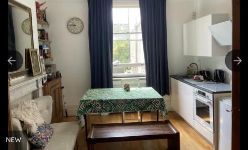 a small kitchen with a table in a room at Cedar House in London