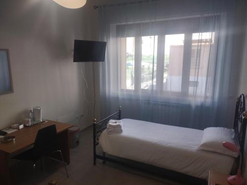 Ένα ή περισσότερα κρεβάτια σε δωμάτιο στο B&B ANNUNZIATA-Vicino all' Ospedale Civile dell'Annunziata e alla Clinica Scarnati, a due passi dall'Ospedale Mariano Santo,Siamo nel centro di Cosenza con facilita' di parcheggio e servizi vari
