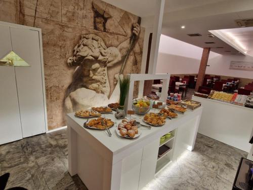 a buffet of food on a table in a room at Hotel Ragno D'Oro in Sottomarina