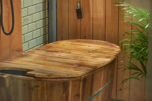 a wooden table in a room with a plant at Spacious 80m2 Private House, central Tokyo in Tokyo