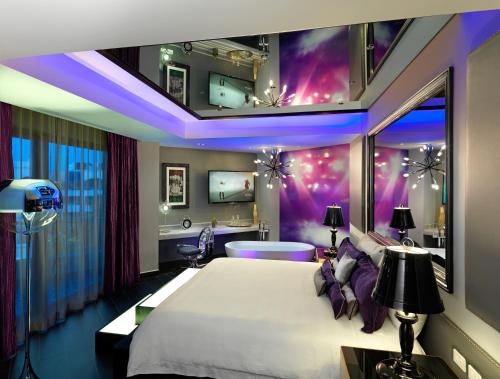 a bedroom with a large white bed and a purple room at Hard Rock Hotel Riviera Maya - Heaven Adults Only - All Inclusive in Puerto Aventuras