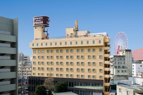 a building with a ferris wheel on top of it at Hotel Taisei Annex in Kagoshima