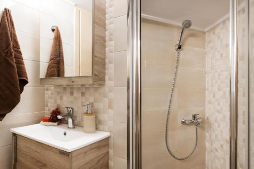 a bathroom with a shower and a sink at Lovely renovated apartment walk to Acropolis in Athens