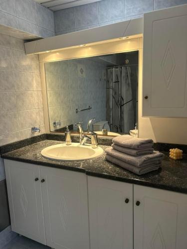 a bathroom counter with a sink and a mirror at New Lindos Studio 45 renovated in Lindos