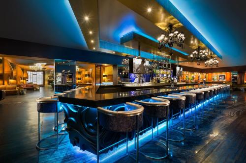 a bar with bar stools at a nightclub at Hard Rock Hotel Riviera Maya - Heaven Adults Only - All Inclusive in Puerto Aventuras