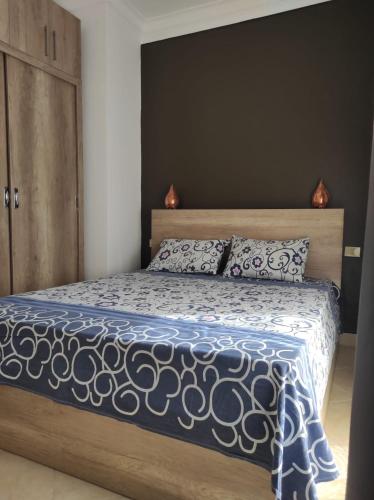 a bedroom with a bed with a blue and white comforter at The Sharm House in Sharm El Sheikh