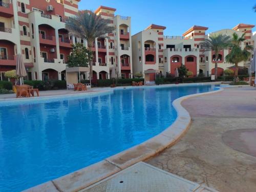 a large swimming pool in front of some apartment buildings at The Sharm House in Sharm El Sheikh
