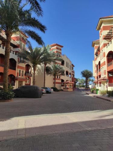 eine Stadtstraße mit Palmen und Gebäuden in der Unterkunft The Sharm House in Sharm El Sheikh